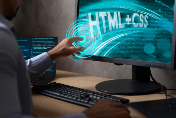 AI in Web Development: A professional interacting with a computer screen displaying HTML and CSS graphics