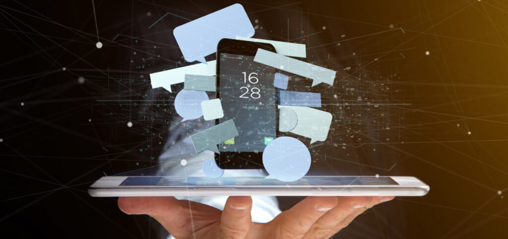 A smartphone emerging from a tablet with speech bubbles and digital connections, symbolizing innovation in Rapid Application Development and mobile app technology